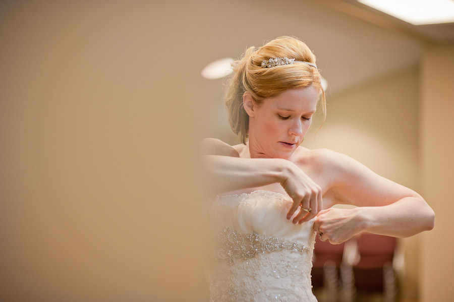 trinity-episcopal-terrys-catering-bloomington-wedding-01 bride fixing dress at church